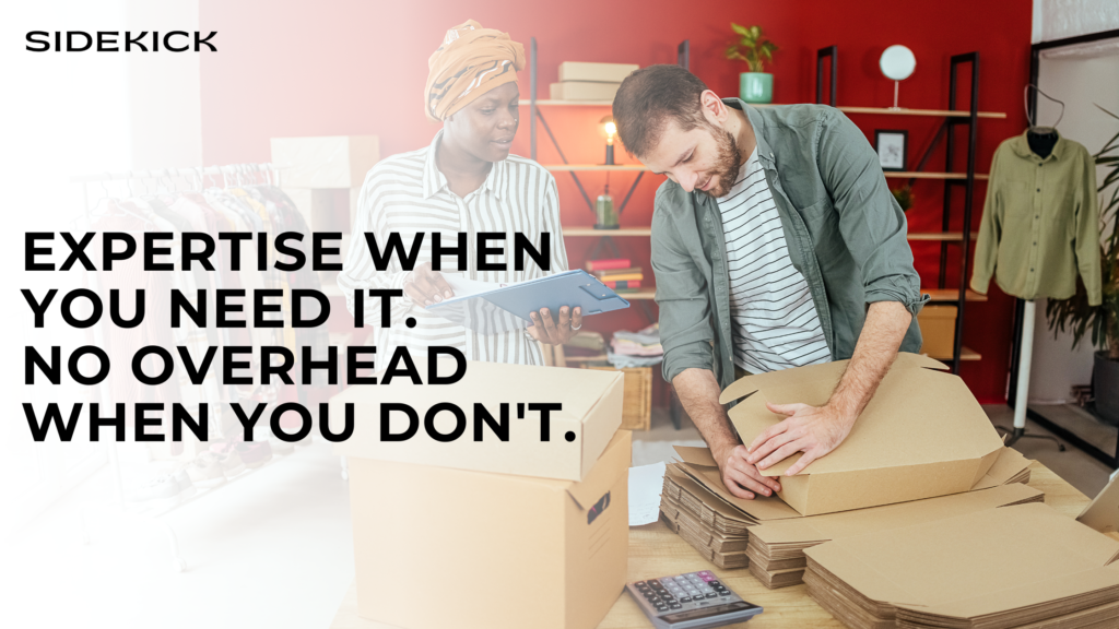 Two small business owners packing boxes in a workspace. One person holds a clipboard while the other folds cardboard packaging. Text reads: ‘Expertise when you need it. No overhead when you don’t.’ with Sidekick logo
